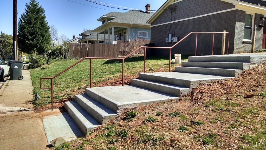 Double line ADA steel stair railings installed on concrete steps and landing